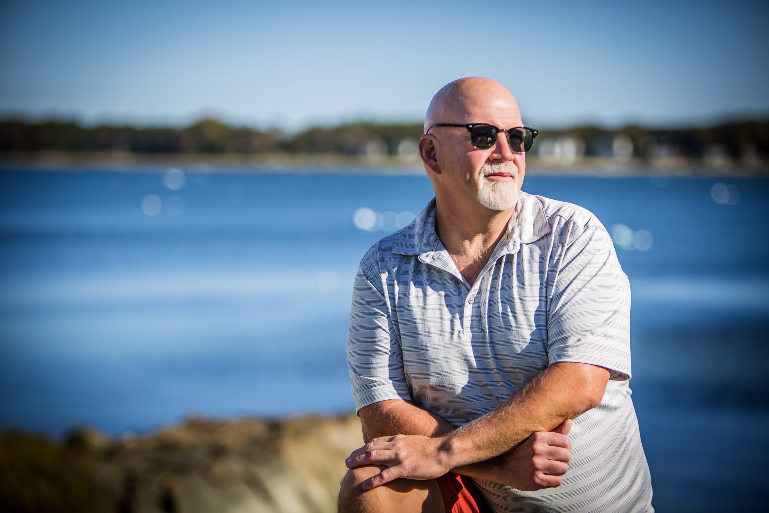 man standing on dock infant of ocean looking off